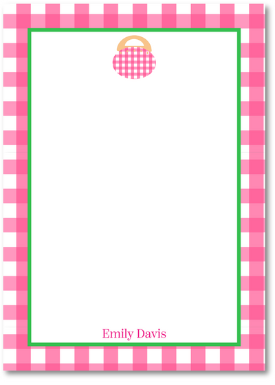 Notepad with pink and white checkered border and a small illustration of a handbag.