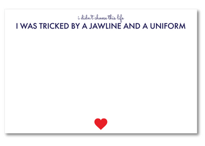 Card with text 'I didn't choose this life I was tricked by a jawline and a uniform' and a red heart on a white background