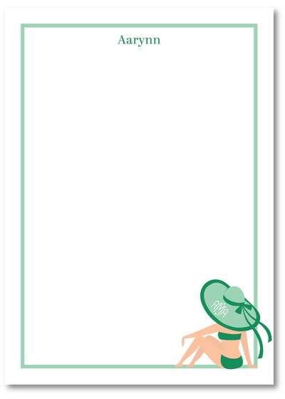 Note pad with a design of a person in a swimsuit holding a green hat, with 'Aarynn' printed at the top.