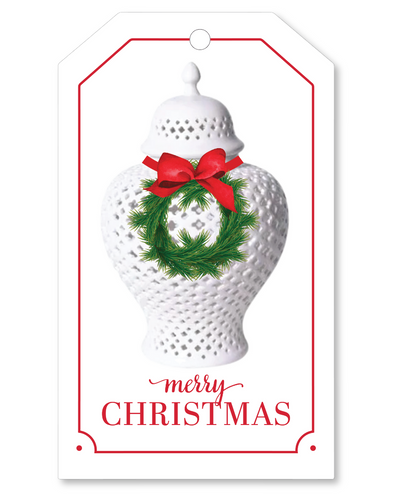 Decorative Christmas tag with a white textured vase, red bow, and green wreath on a white background.