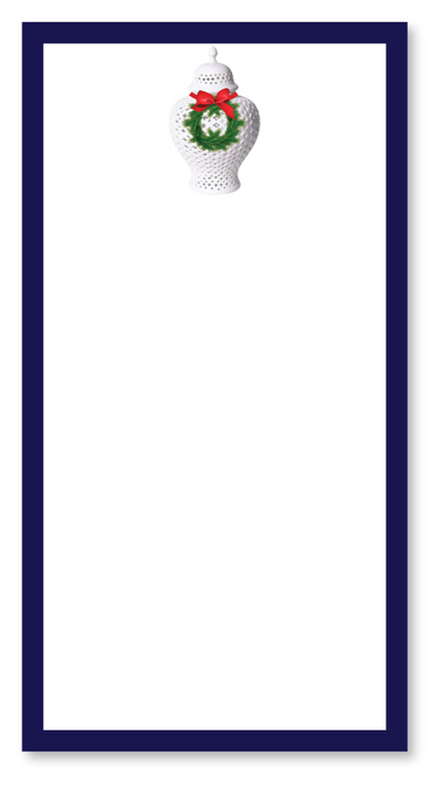 Notepad with a decorative design of a white vase with a wreath and red bow on a blue border.