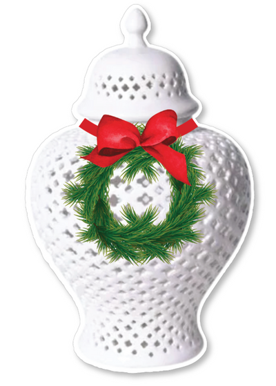 Decorative white ginger jar with a green wreath and red bow on a white background