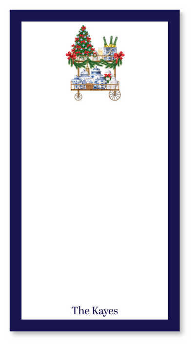 Notepad with a Christmas design of a cart with gifts and tree, on a white background.
