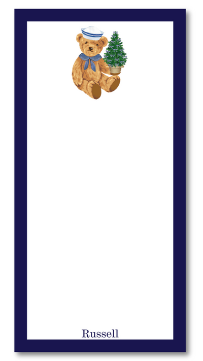Notepad with a teddy bear holding a Christmas tree design on a white background