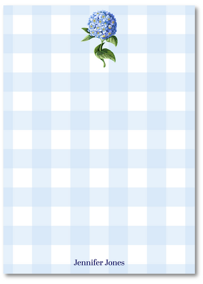 Notepad with blue flower design on a light blue and white checkered background
