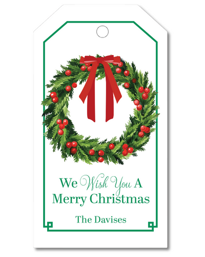Christmas gift tag with wreath and red ribbon on a white background