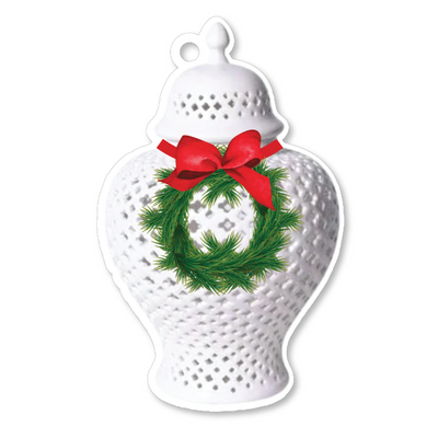 Decorative white ginger jar with a green wreath and red bow on a white background