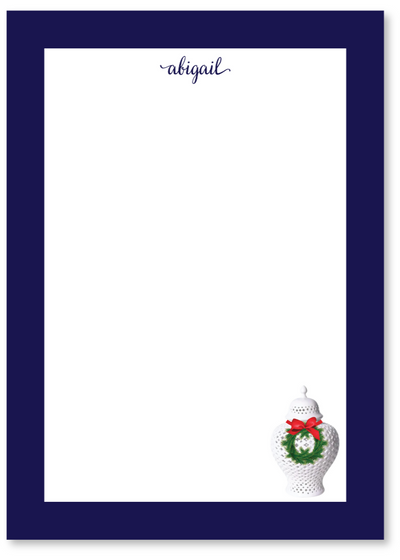 Preppy notepad with a white ginger jar with a wreath and bow on a blue border, featuring the name 'abigail'.