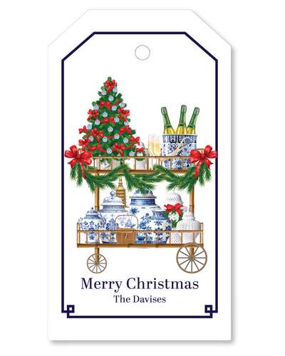 Christmas-themed gift tag with a cart, tree, and bottles on a white background