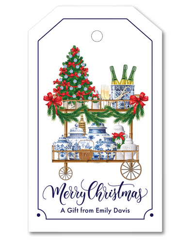 Gift tag with Christmas-themed cart, tree, and decorations on a white background