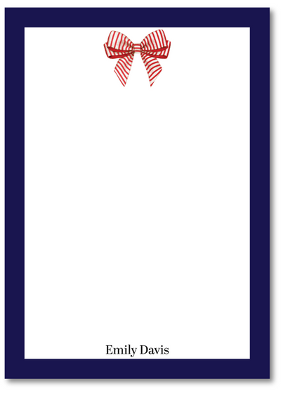 Note card with a red bow design and blue border on a white background
