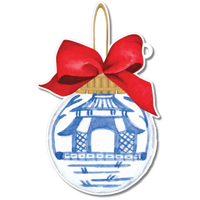Decorative ornament with blue pagoda design and red bow on a white background