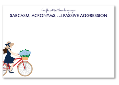 Note card with a illustration of a woman on a bike carrying flowers and text about languages.